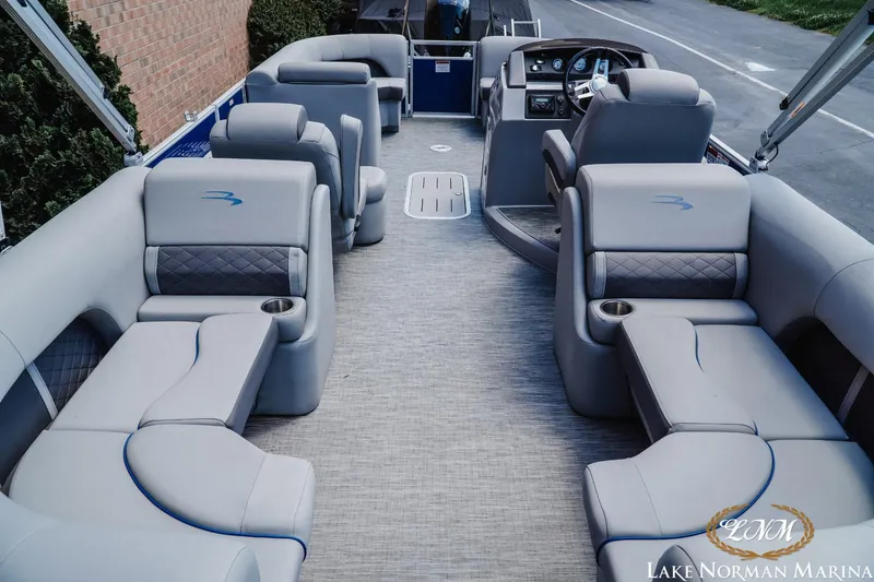 Slide: The Image of 2023 Bennington 23LSR pontoon boat interior with luxurious seating and modern dashboard. - 5