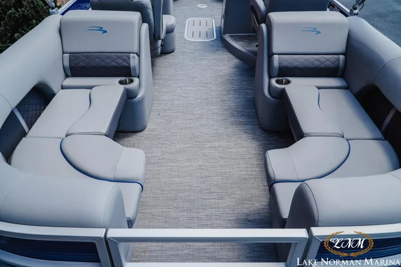 Slide: The Image of 2023 Bennington 23LSR pontoon boat interior with plush seating and cup holders. - 6