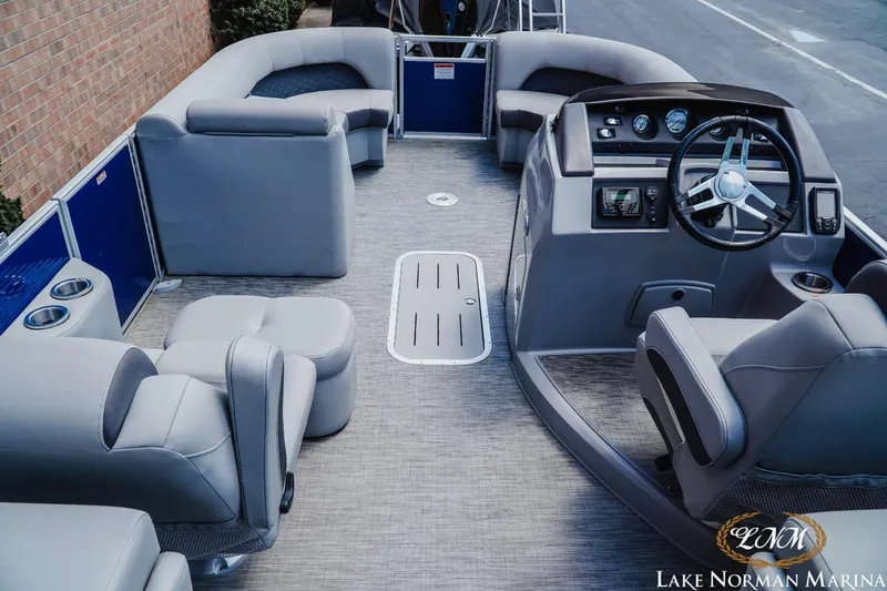 Slide: The Image of 2023 Bennington 23LSR pontoon boat interior with plush seating and modern helm. - 7