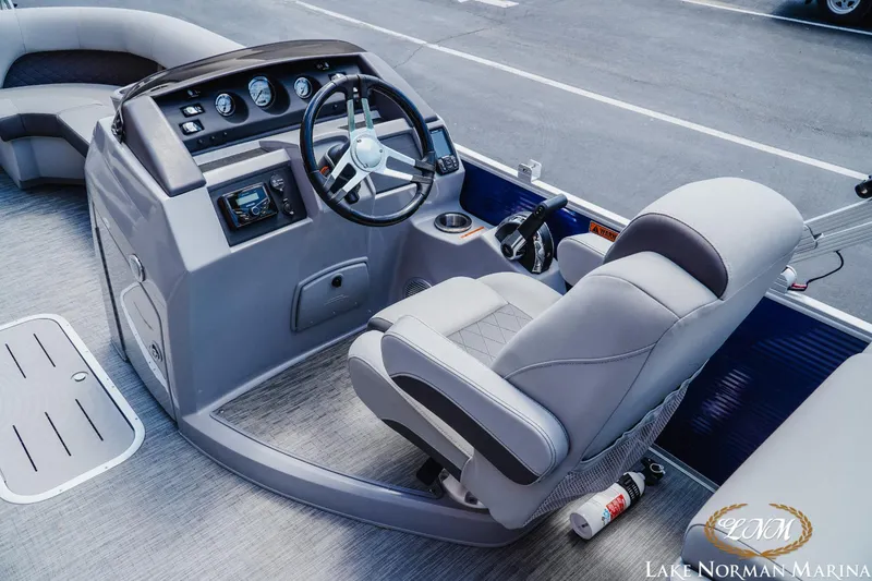 Slide: The Image of 2023 Bennington 23LSR boat cockpit with steering wheel and control panel. - 8