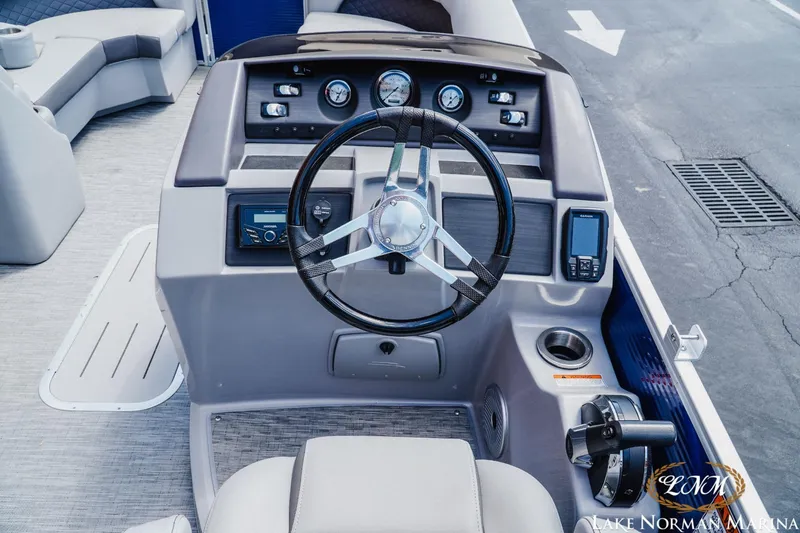 Slide: The Image of 2023 Bennington 23LSR boat dashboard with steering wheel and control panel. - 9