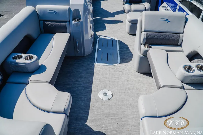 Slide: The Image of 2023 Bennington 23LSR pontoon boat interior with plush seating and cup holders. - 10