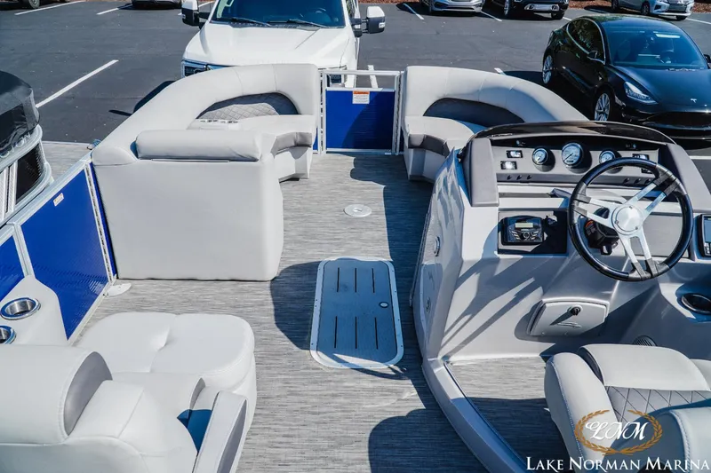 Slide: The Image of 2023 Bennington 23LSR pontoon boat interior with plush seating and modern dashboard. - 6