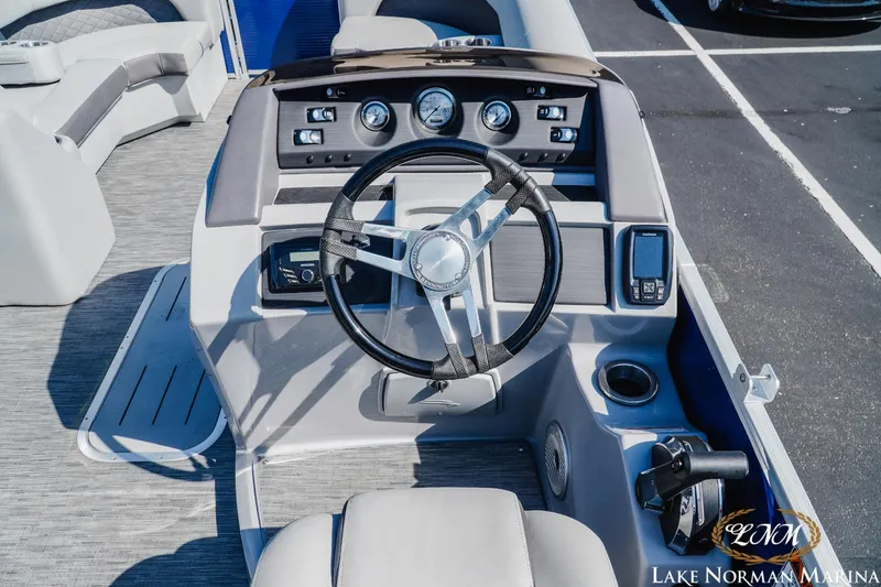 Slide: The Image of 2023 Bennington 23LSR boat dashboard with steering wheel and control panel at Lake Norman Marina. - 8