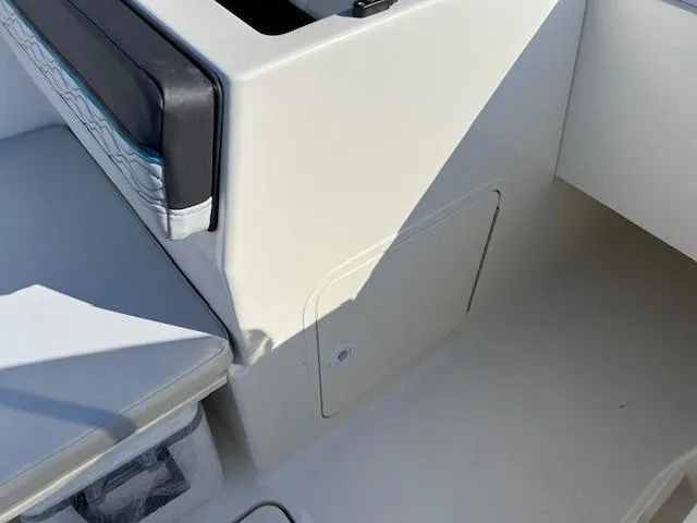 Slide: The Image of 2024 Bayliner Element M19 boat interior seating and storage compartment. - 8