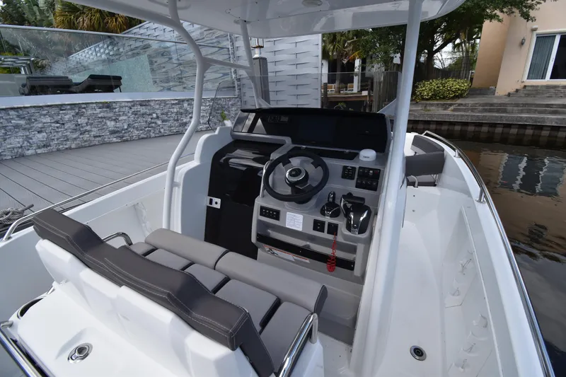 Slide: The Image of 2022 Jeanneau 7.5 Leader boat cockpit with modern steering console and seating. - 14