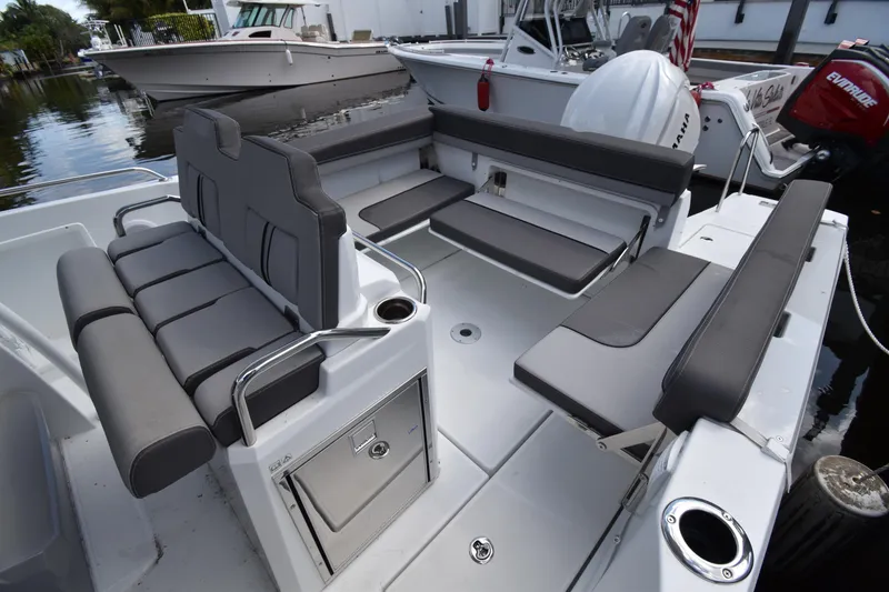 Slide: The Image of 2022 Jeanneau 7.5 Leader boat interior with gray seating and storage compartments. - 15