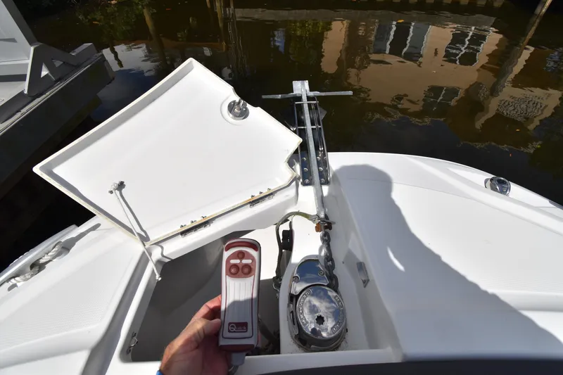 Slide: The Image of 2022 Jeanneau 7.5 Leader boat anchor compartment with remote control. - 17