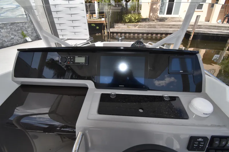 Slide: The Image of 2022 Jeanneau 7.5 Leader dashboard with modern navigation and control systems. - 2