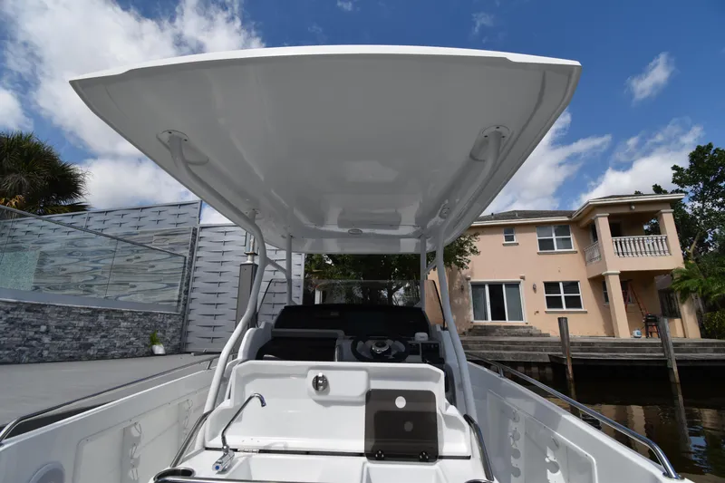 Slide: The Image of 2022 Jeanneau 7.5 Leader boat with T-top, docked near waterfront home. - 4