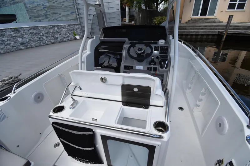 Slide: The Image of 2022 Jeanneau 7.5 Leader boat interior with helm, sink, and storage compartments. - 5