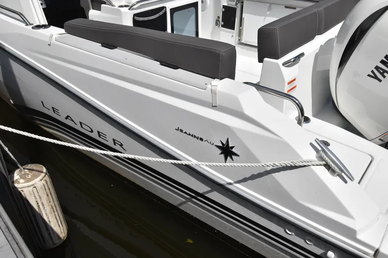 Slide: The Image of 2022 Jeanneau 7.5 Leader boat docked, showcasing sleek design and branding. - 7
