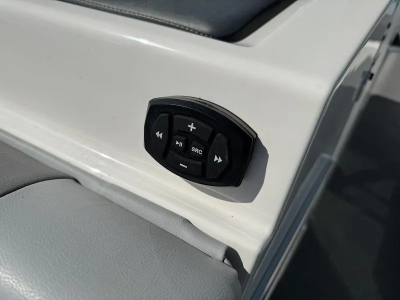 Slide: The Image of MasterCraft XT24 2022 boat audio control panel on white and gray interior. - 10