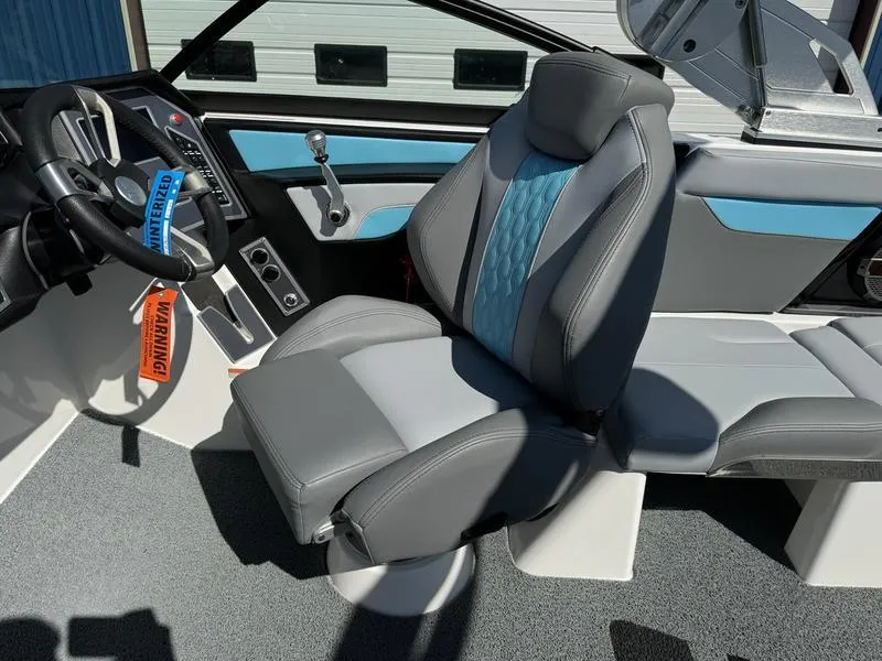 Slide: The Image of 2022 MasterCraft XT24 boat interior with captain's chair and dashboard. - 11
