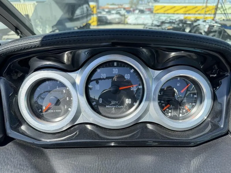 Slide: The Image of 2022 MasterCraft XT24 dashboard with speedometer, tachometer, and fuel gauge. - 13