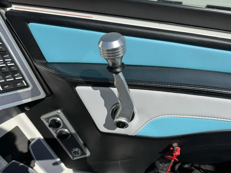 Slide: The Image of 2022 MasterCraft XT24 boat throttle control and dashboard details. - 14