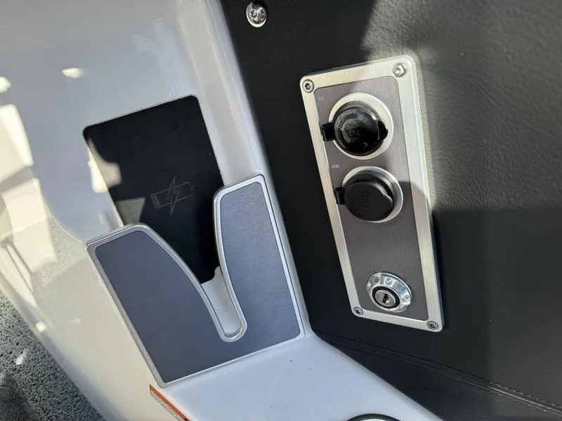 Slide: The Image of Control panel and storage compartment in a 2022 MasterCraft XT24 boat. - 15