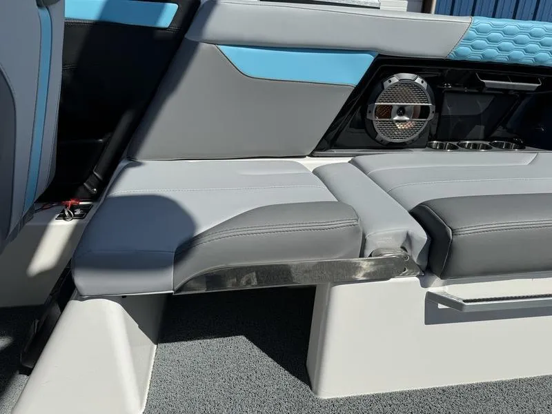 Slide: The Image of 2022 MasterCraft XT24 boat interior with blue and gray seating and speaker. - 16