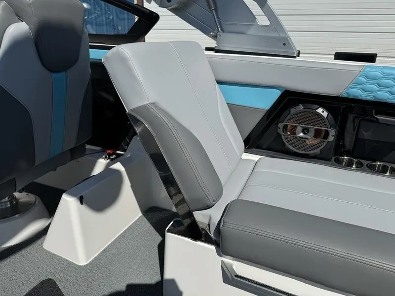 Slide: The Image of 2022 MasterCraft XT24 boat interior with gray and blue seating. - 17
