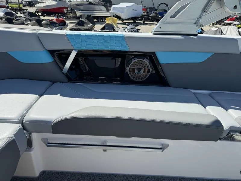 Slide: The Image of 2022 MasterCraft XT24 boat interior with blue and gray seating. - 21