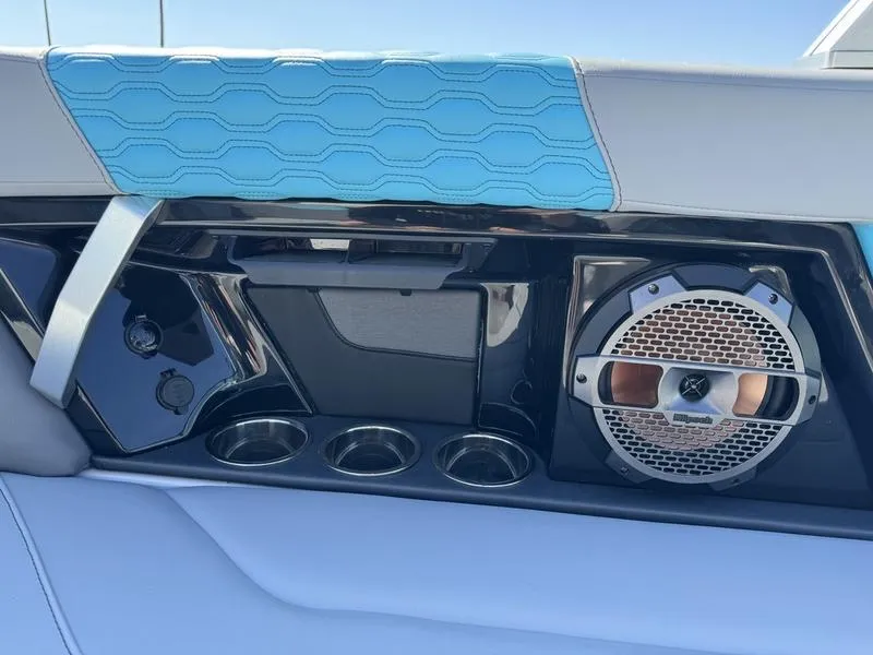 Slide: The Image of 2022 MasterCraft XT24 boat interior with speaker and cup holders. - 22