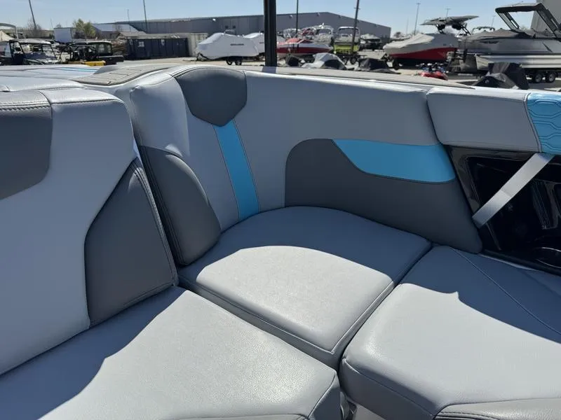 Slide: The Image of 2022 MasterCraft XT24 boat interior with gray and blue seating. - 23