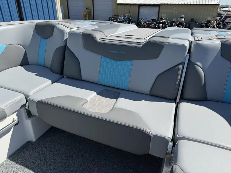 Slide: The Image of 2022 MasterCraft XT24 boat interior with gray and blue seating. - 24