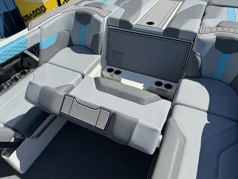 Slide: The Image of 2022 MasterCraft XT24 boat interior with gray and blue seating. - 25