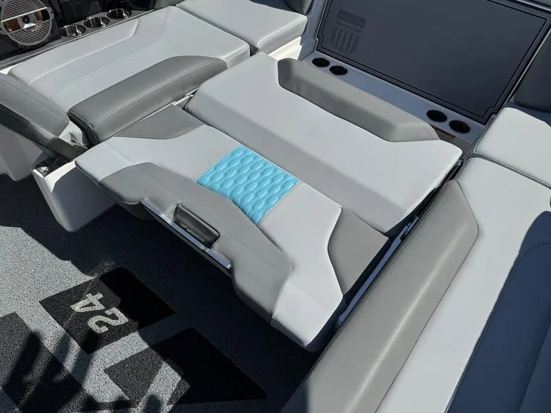 Slide: The Image of 2022 MasterCraft XT24 boat interior with gray and blue seating. - 26