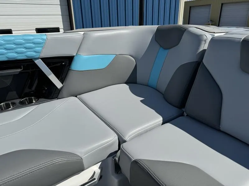 Slide: The Image of 2022 MasterCraft XT24 boat interior with gray and blue seating. - 27