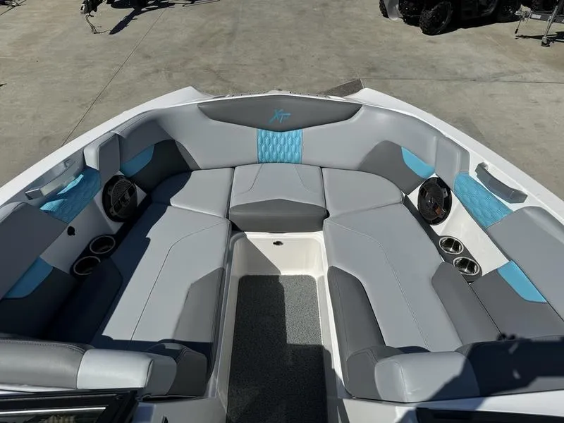 Slide: The Image of 2022 MasterCraft XT24 boat interior with gray and blue seating. - 28