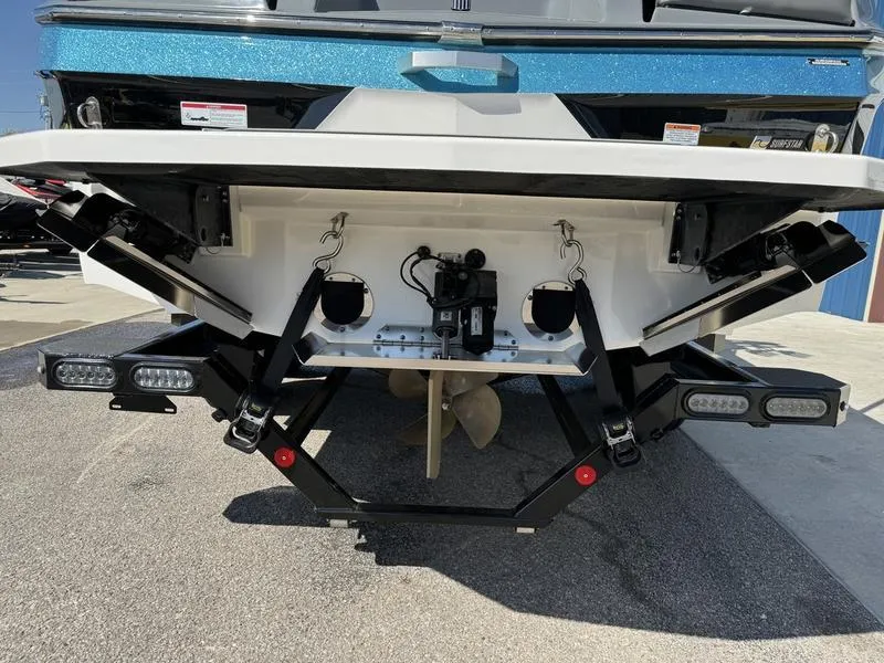 Slide: The Image of 2022 MasterCraft XT24 boat rear view with propeller and trim tabs. - 3