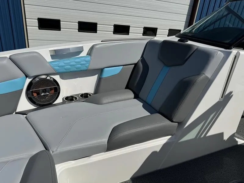 Slide: The Image of 2022 MasterCraft XT24 boat interior with gray and blue seating. - 30
