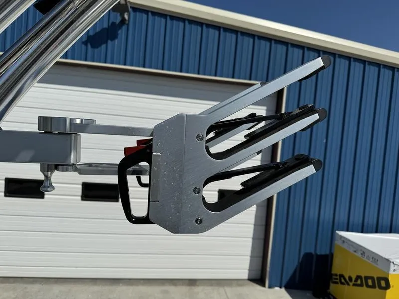 Slide: The Image of 2022 MasterCraft XT24 wakeboard rack against blue building background. - 34