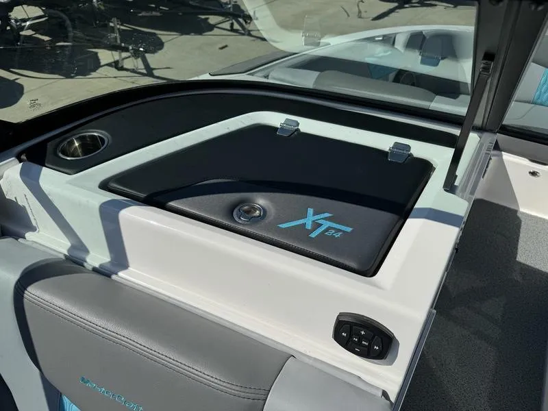Slide: The Image of 2022 MasterCraft XT24 boat interior dashboard with storage compartment. - 9