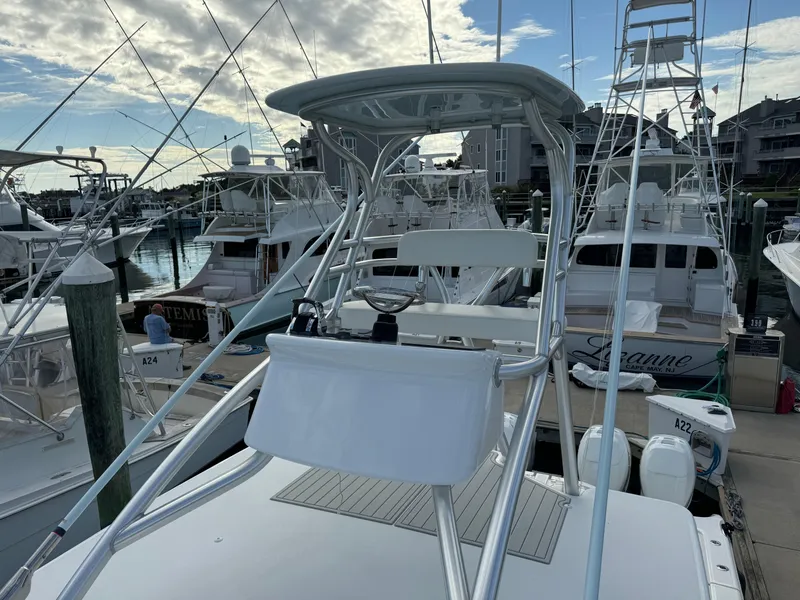 Slide: The Image of 2020 Invincible 40 Catamaran docked at marina with clear sky and surrounding boats. - 14