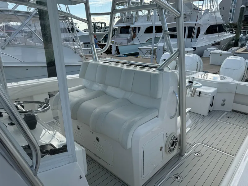 Slide: The Image of 2020 Invincible 40 Catamaran interior with white seating and steering wheel, docked at marina. - 15