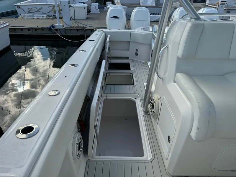 Slide: The Image of 2020 Invincible 40 Catamaran deck with storage compartments and seating at marina. - 20