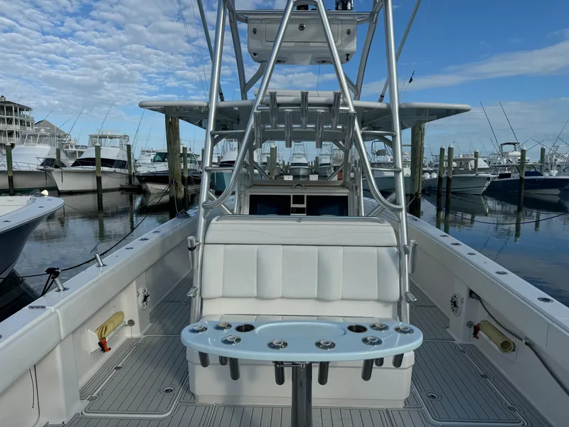 Slide: The Image of Invincible 40 Catamaran 2020 at marina, featuring spacious deck and fishing rod holders. - 21