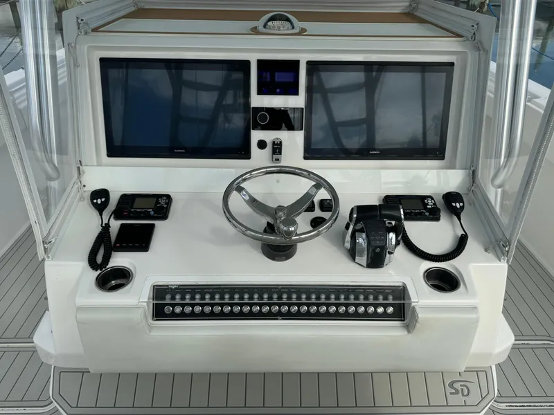 Slide: The Image of Control panel of a 2020 Invincible 40 Catamaran with dual screens and steering wheel. - 29