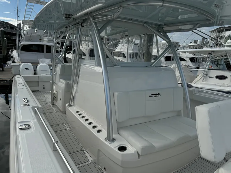 Slide: The Image of 2020 Invincible 40 Catamaran with sleek seating and modern design at a marina. - 30