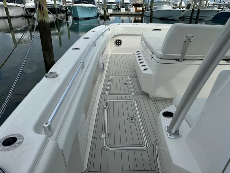 Slide: The Image of Invincible 40 Catamaran 2020 model, sleek deck design, docked at marina. - 33