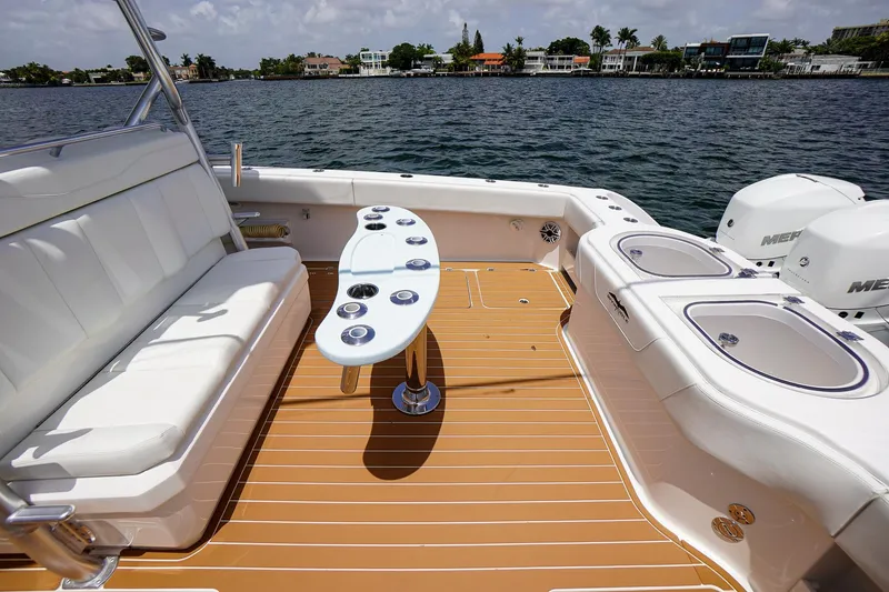 Slide: The Image of 2020 Invincible 40 Catamaran deck with seating, table, and ocean view. - 4