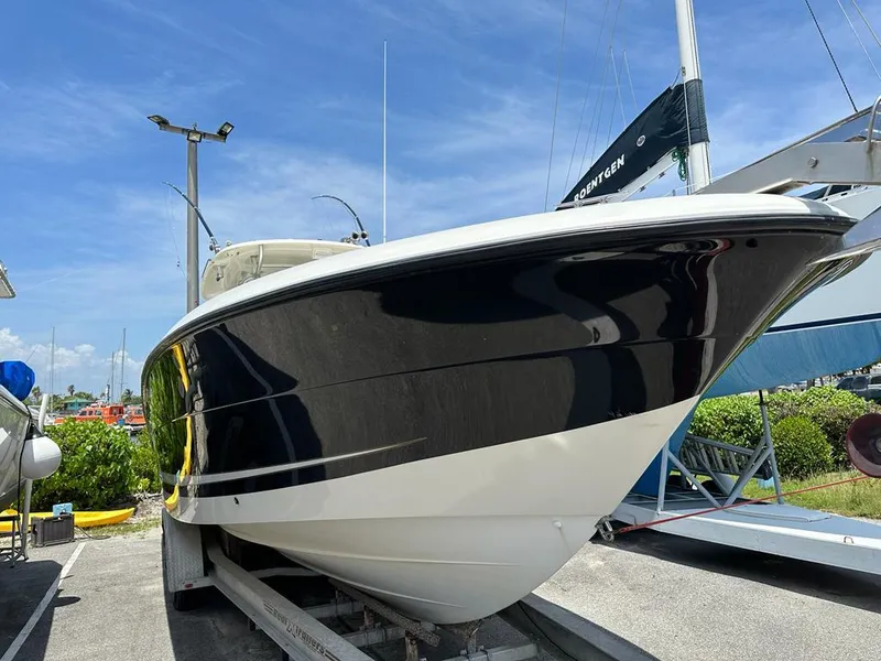 Slide: The Image of 2007 Hydra-Sports Vector 3300 CC boat on trailer, sleek black and white design. - 3