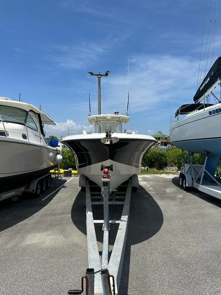 Slide: The Image of 2007 Hydra-Sports Vector 3300 CC boat on trailer, parked between two other boats. - 4