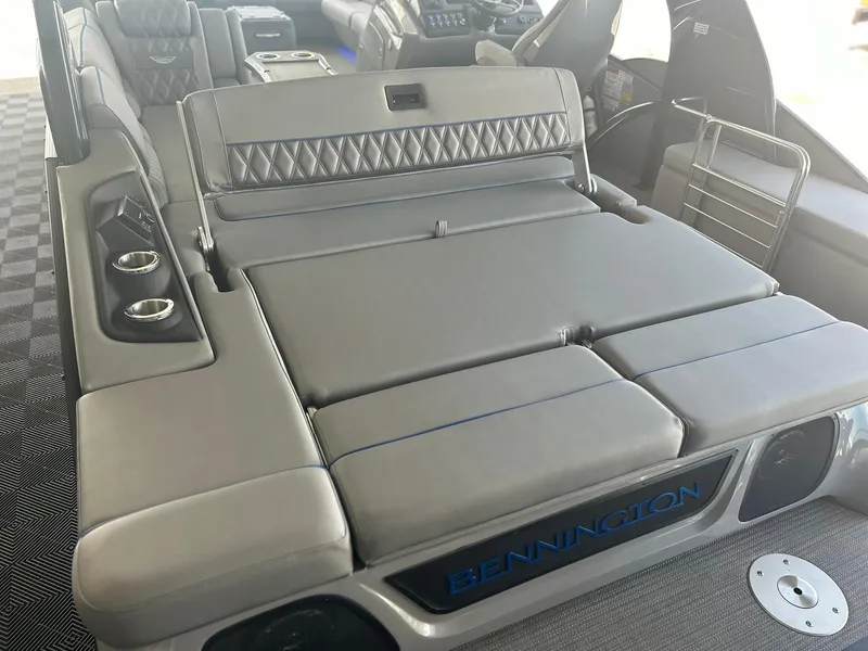 Slide: The Image of 2024 Bennington 28 QXSBA x1 boat interior with luxurious seating and cup holders. - 14