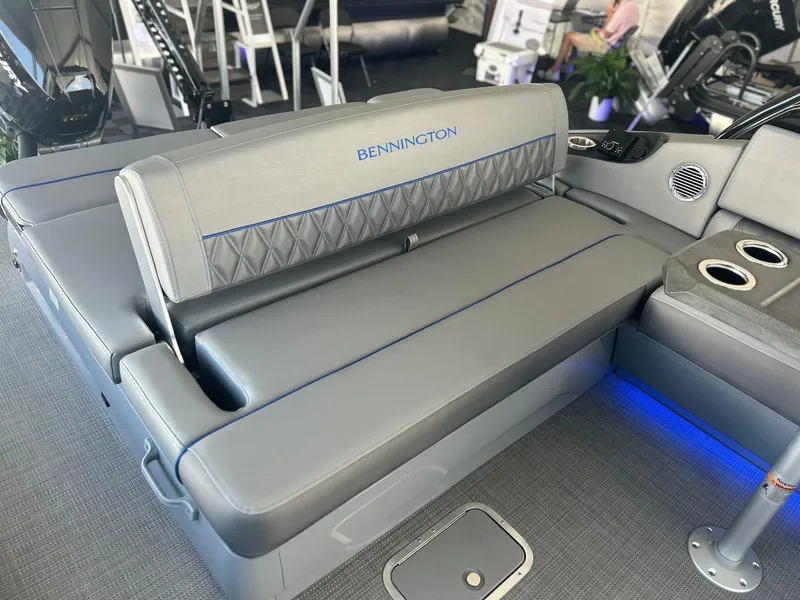 Slide: The Image of 2024 Bennington 28 QXSBA x1 boat interior with gray seating and blue accents. - 15
