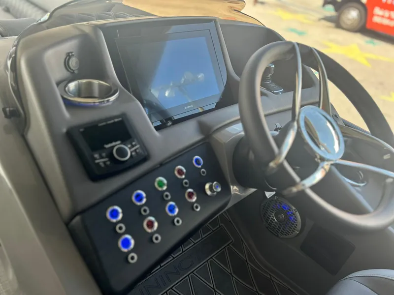Slide: The Image of 2024 Bennington 28 QXSBA x1 boat dashboard with steering wheel and control panel. - 18