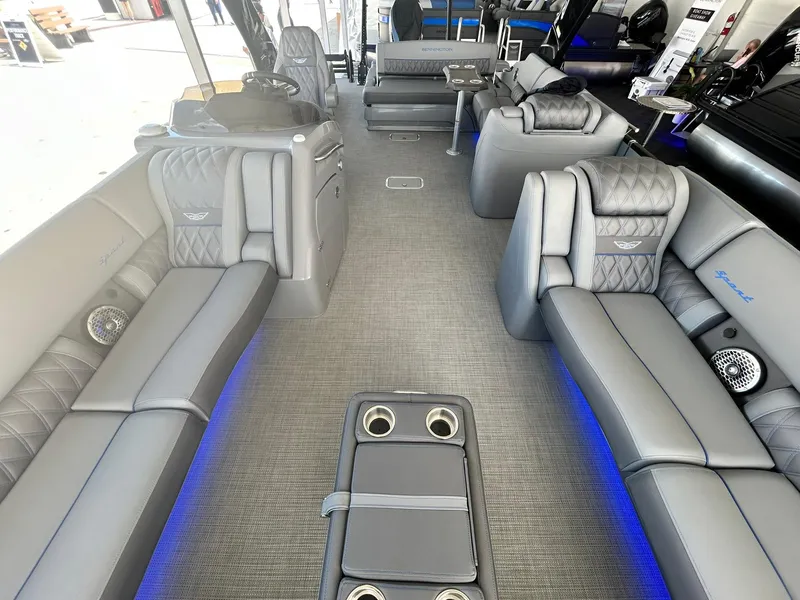 Slide: The Image of 2024 Bennington 28 QXSBA x1 luxury pontoon boat interior with plush seating and blue LED lighting. - 22