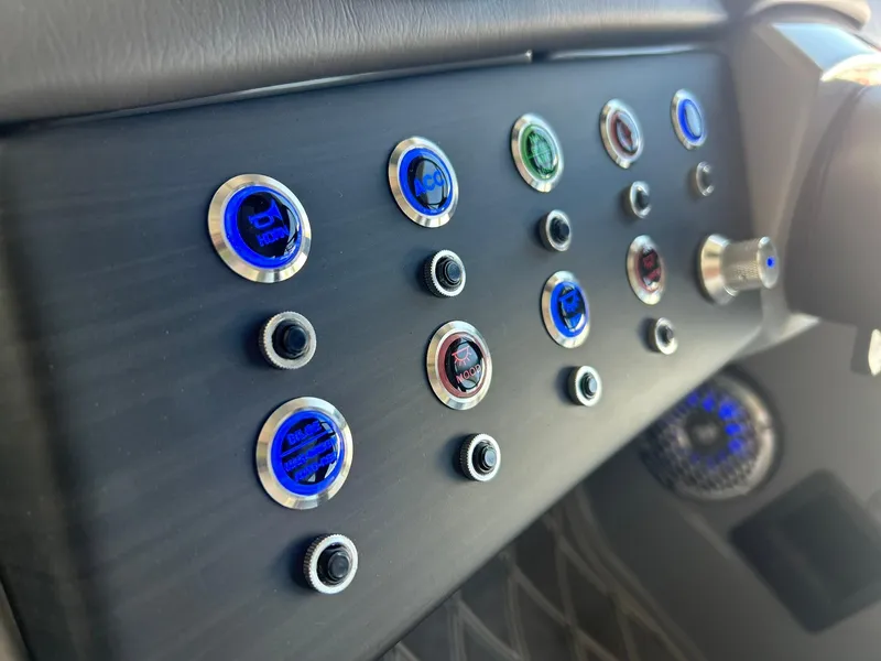 Slide: The Image of Control panel of 2024 Bennington 28 QXSBA x1 boat with illuminated buttons. - 24